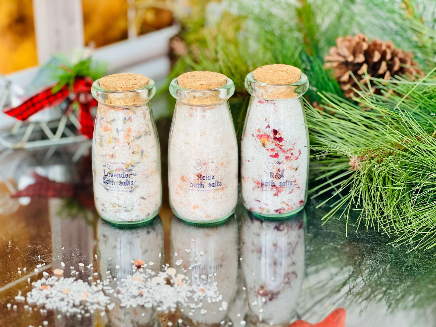 Handcrafted bath salts in glass jars: lavender, rose, and unscented varieties, beautifully displayed with festive decor.