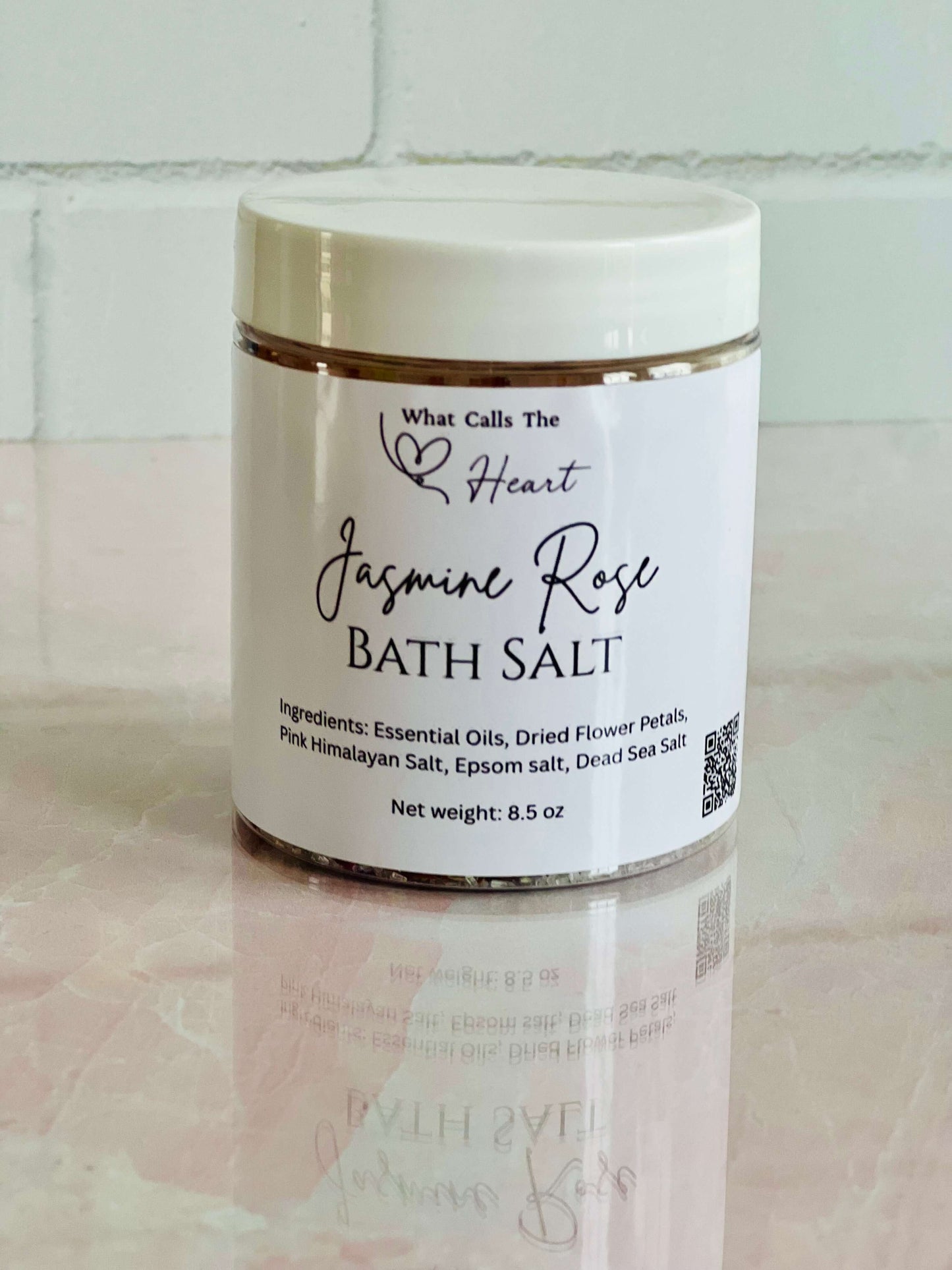 Jasmine Rose Bath Salts in an 8.5 oz container with essential oils and dried flower petals for relaxation.