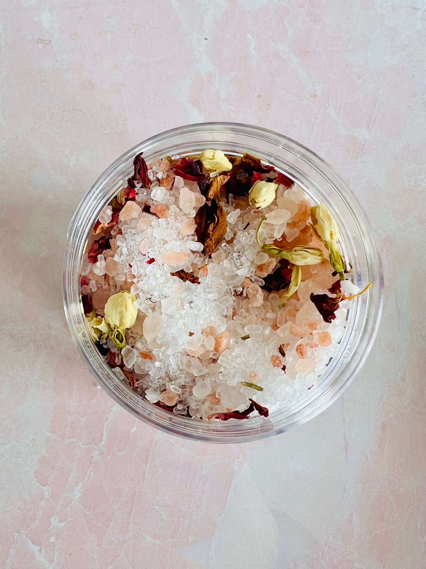 Jasmine Rose Bath Salts in clear container with pink Himalayan salt and dried flower petals.