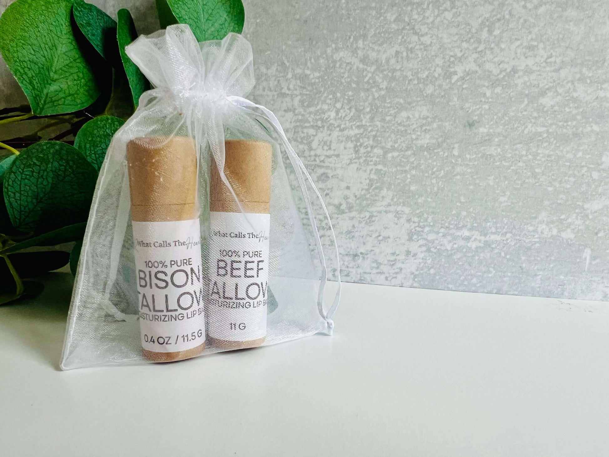 Two organic lip balms in a gift bag, featuring 100% pure beef and bison tallow for moisturizing benefits.
