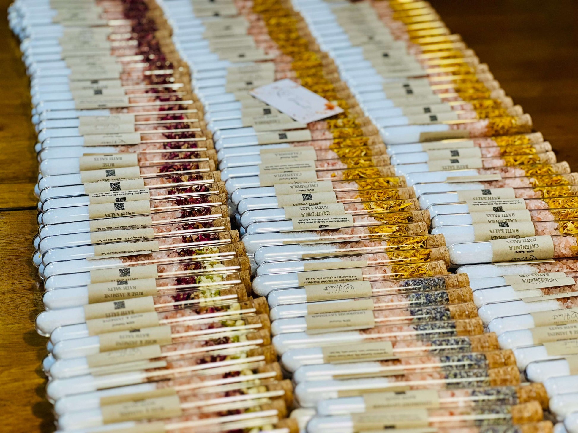 Variety pack of bath salts displayed in test tubes, showcasing natural ingredients and therapeutic properties.