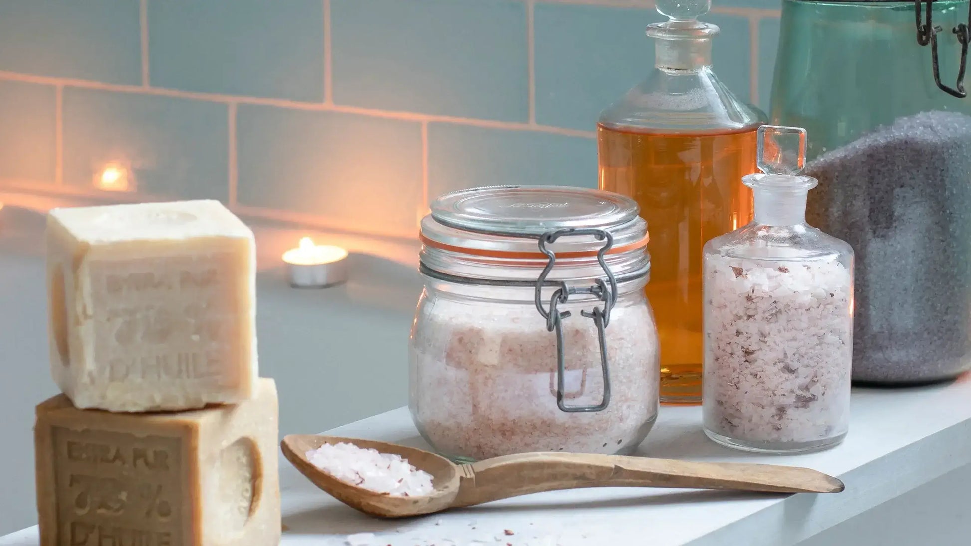 Serene bath setup with natural bath salts, soap bars, and essential oils, creating a relaxing atmosphere.