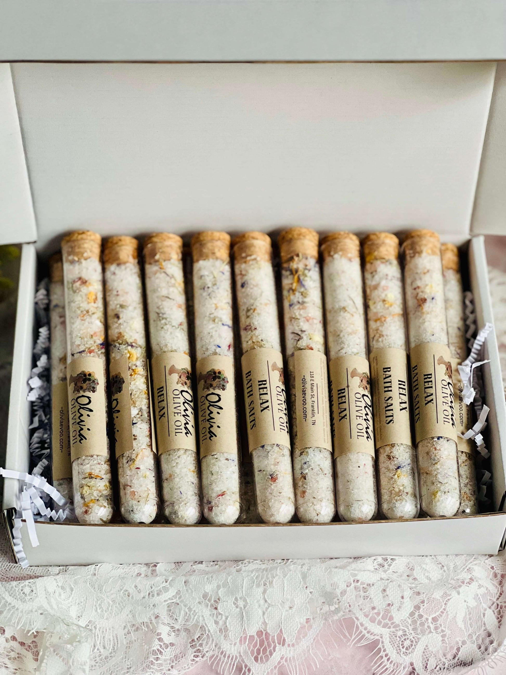 Mixed bath salts in glass tubes, featuring natural ingredients like Epsom and Himalayan salt, displayed in a gift box.