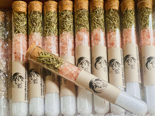Rosemary bath salts in glass tubes with cork tops, featuring pink Himalayan salt and dried rosemary.