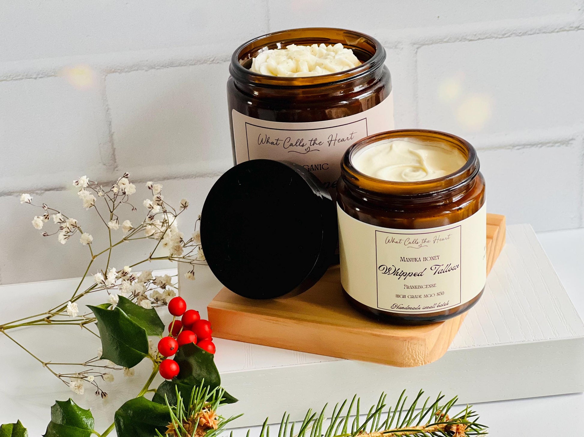 The 2 oz jar is in front of a larger jar.